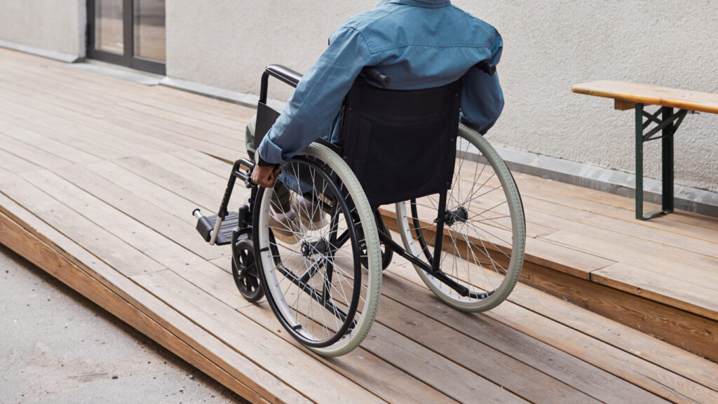 Disabled man moving along ramp